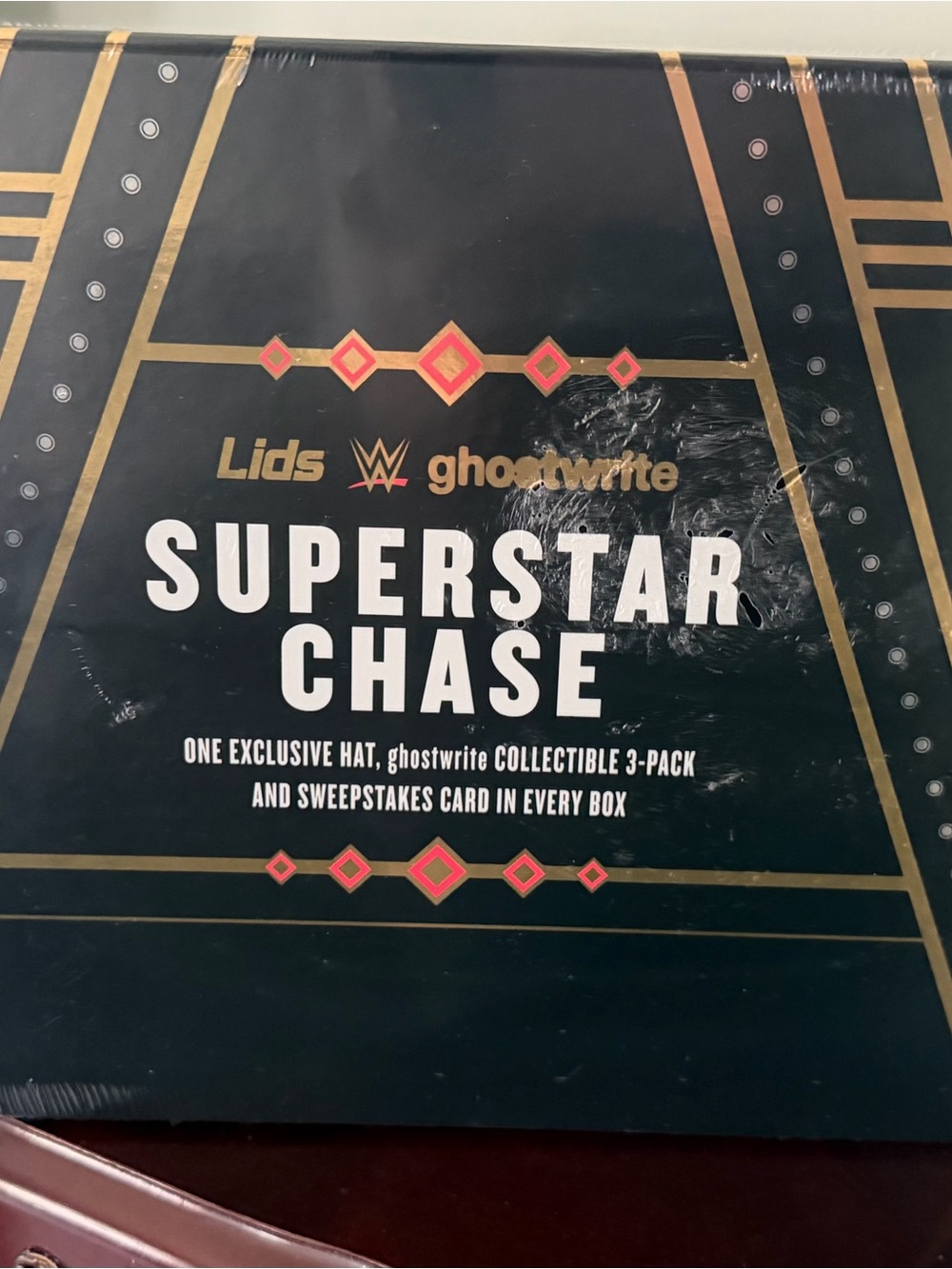 WWE Superstar Chase Collector Box in Black and Gold with Red Accents